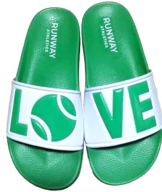 The Runway Athletics Tennis LOVE After Play Tennis Slides in green & white feature "L" and a tennis ball "O" on the left strap, "VE" on the right, and RUNWAY ATHLETICS printed on each footbed—perfect as a fun tennis gift.