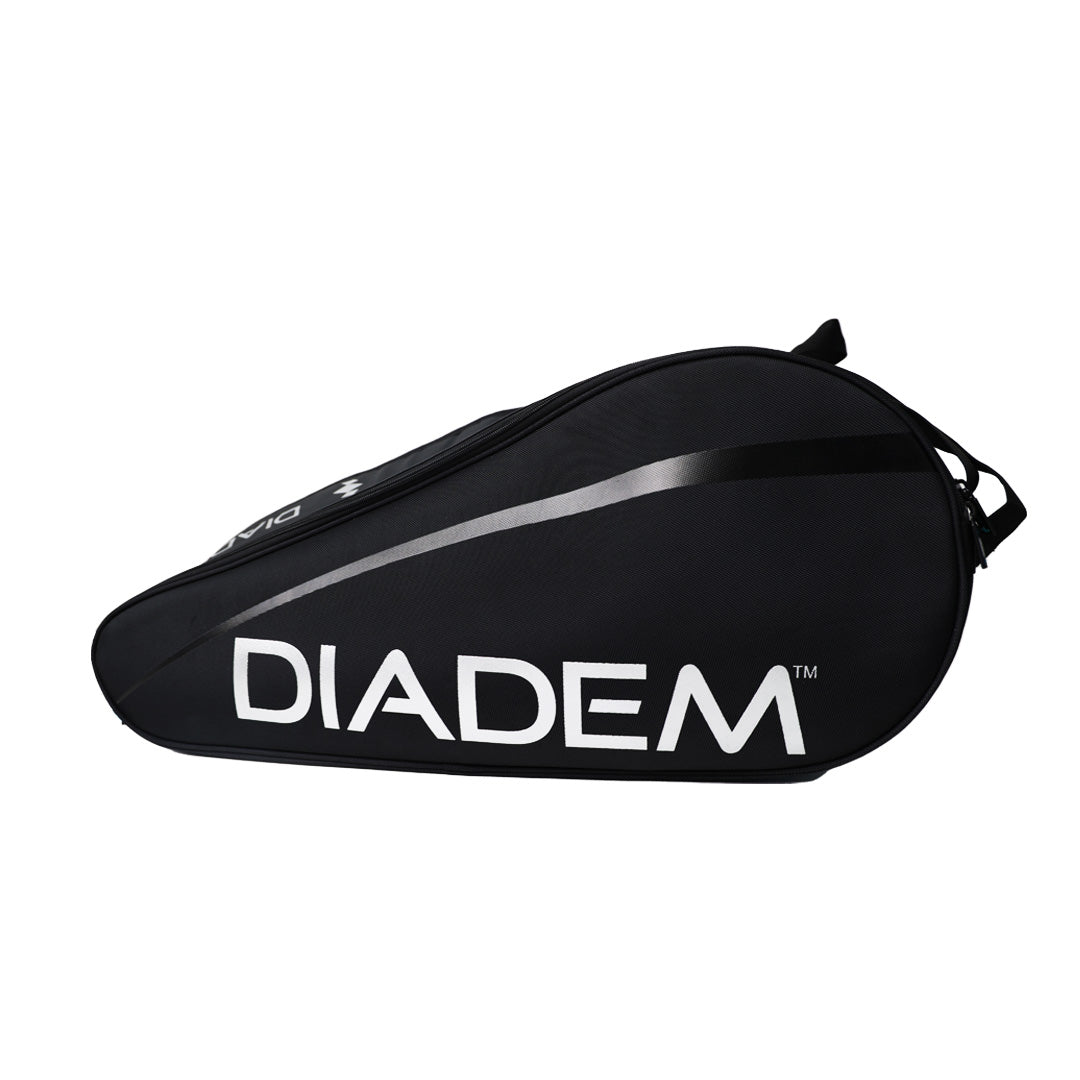 The Diadem Sports Tour v3 12PK is a black racket bag with “DIADEM” in large white letters, a teardrop shape, top zipper, black handle, and dark gray stripe—stylish and ideal for tennis gear.