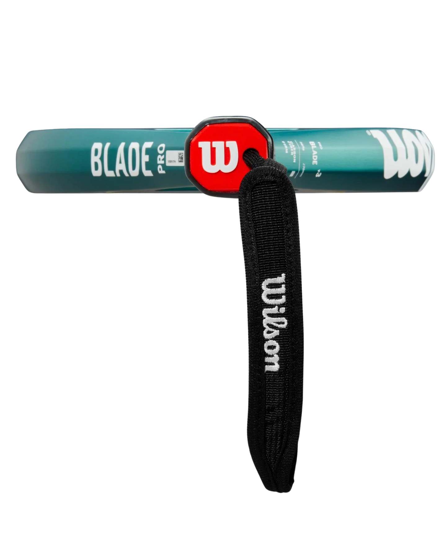 A close-up of the Wilson Blade PRO V3 by Padel USA shows its green carbon fiber grip, red circular end cap with a white W logo, and a black wrist strap with "Wilson" in white text attached to the handle.