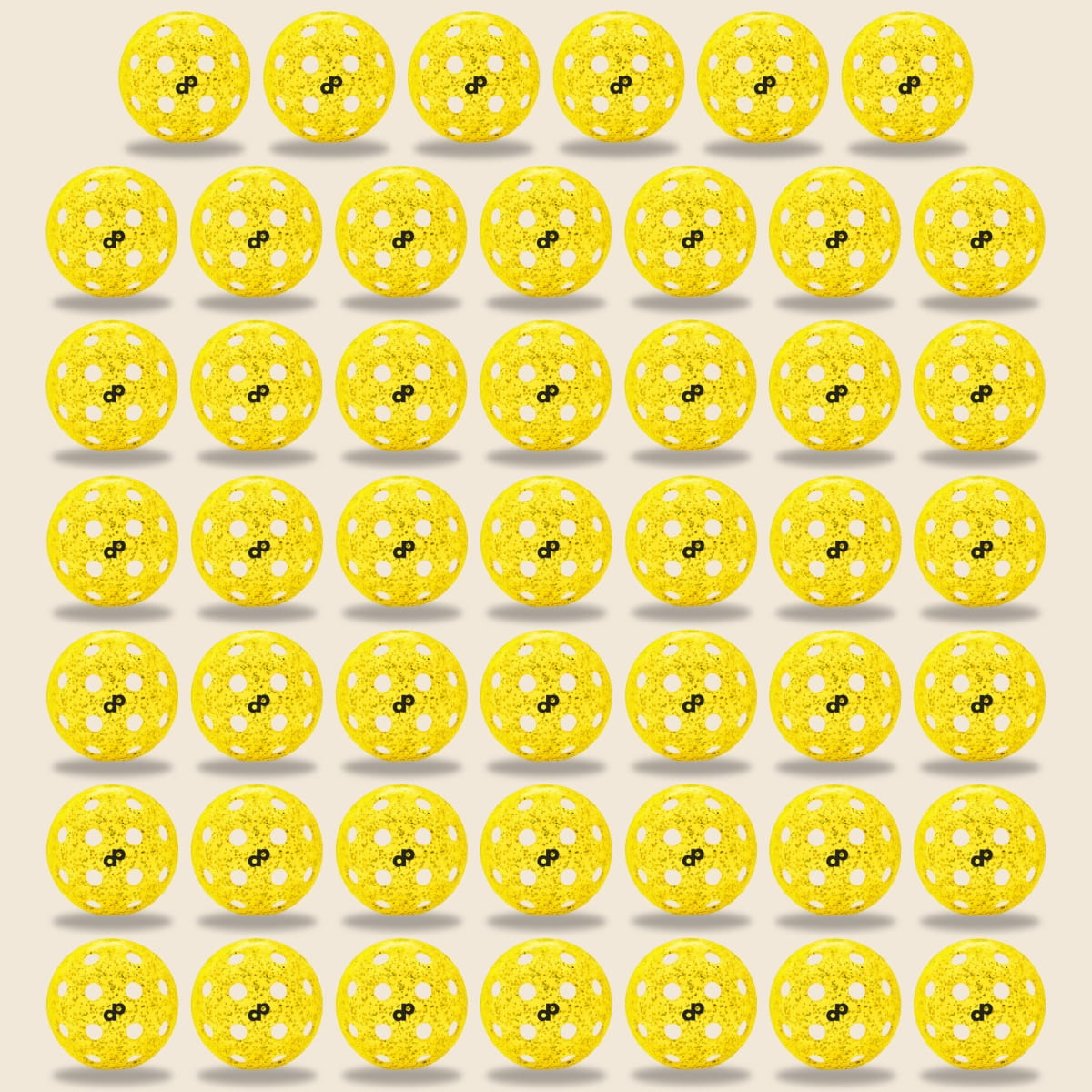 A 7x7 grid of Dope Pickleball Co. Yellow Glitter-Infused Pickleball Balls with white accents and a black infinity symbol sits on a light beige background. Sparkling details boost visibility, and shadows beneath each ball add depth.