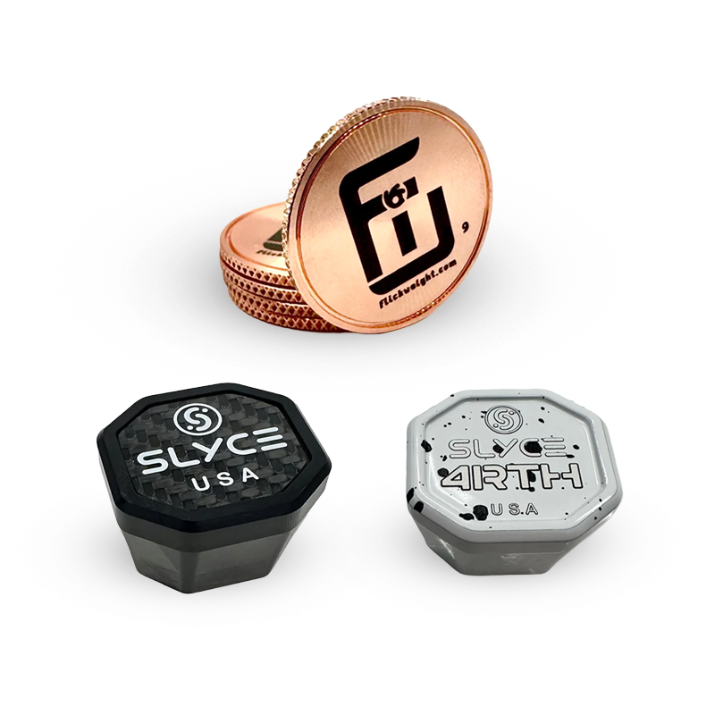 Two copper coins with the Fü logo stand upright, and in front, two octagonal grinder containers labeled “Slyce USA” and “Slyce 4RTH USA” in black and gray, all on a white background.