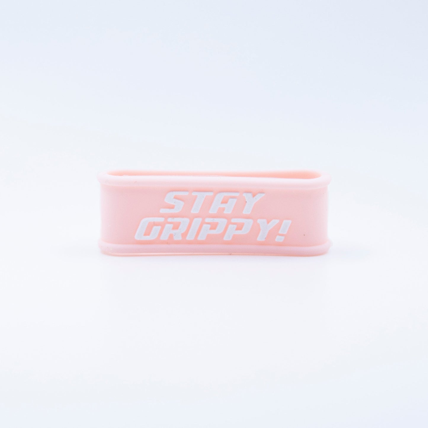 A light pink Bodhi Performance Paddle Band with rounded edges is centered on a white background. "STAY GRIPPY!" is printed in bold, white, uppercase letters—perfect as a silicone grip accessory for pickleball paddles.