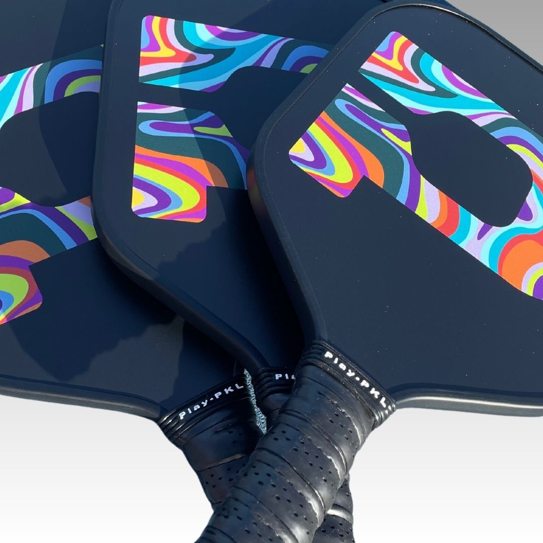 The Playly Store Signature Pickleball Paddle features a durable graphite surface, a responsive honeycomb core, and comes in a variety of colorful designs.