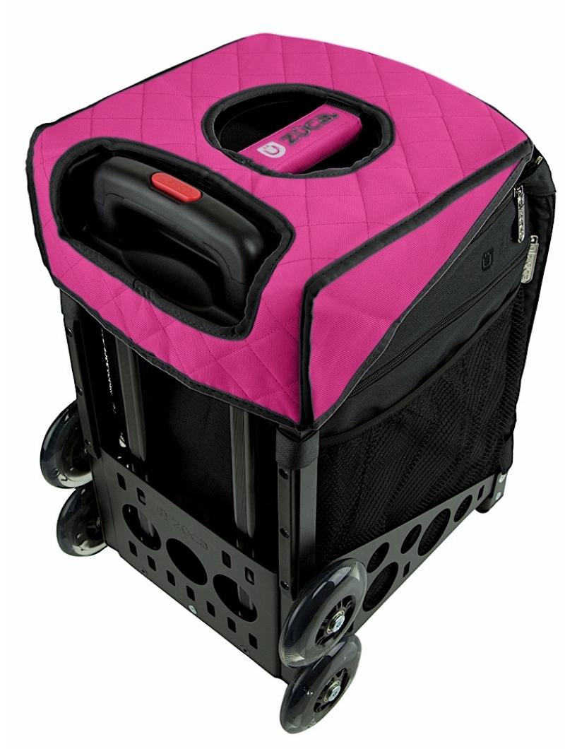 A black rolling crate with four wheels, extendable handle, mesh pockets, pink quilted fabric cover, zippered compartment, visible pink ZUCA accessory pouch, and an optional ZUCA Reversible Seat Cushion.
