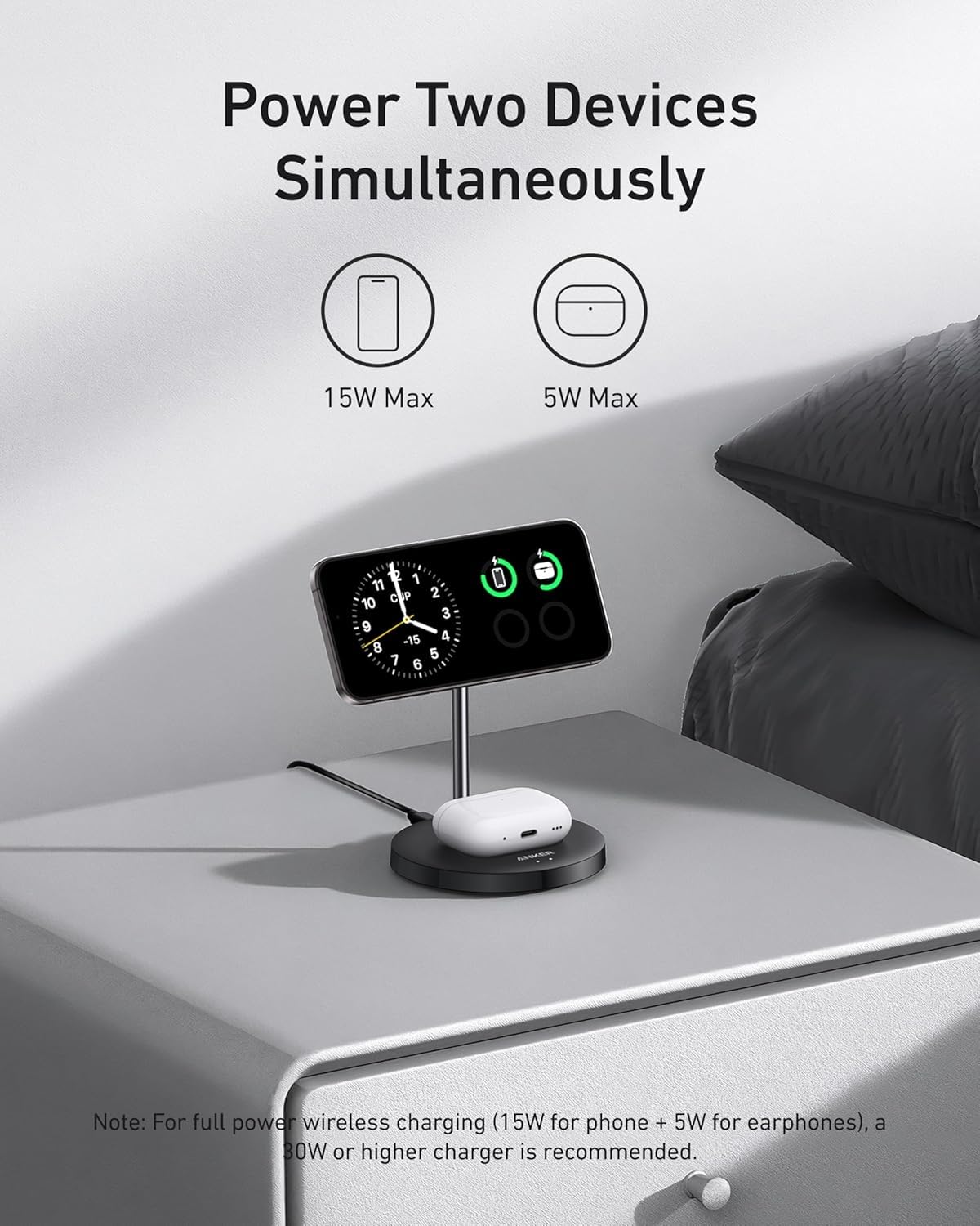 Anker MagGo Wireless Charger (2-in-1 Stand) BOA by Anker on a bedside table powers your phone and wireless earbuds together. Text reads “Power Two Devices Simultaneously” with 15W fast charging and 5W max charging icons shown above.