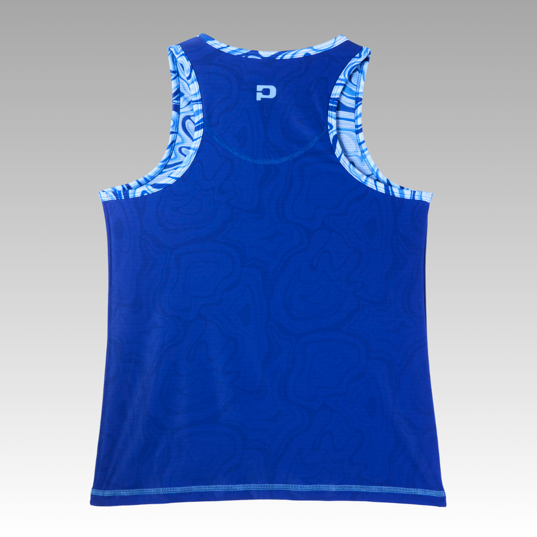 The Playly Store Pretty Tank in royal blue is shown from the back, featuring a subtle pattern, mesh fabric, and abstract blue-and-white trim on the armholes and neckline. A white logo appears near the top against a gray gradient background.