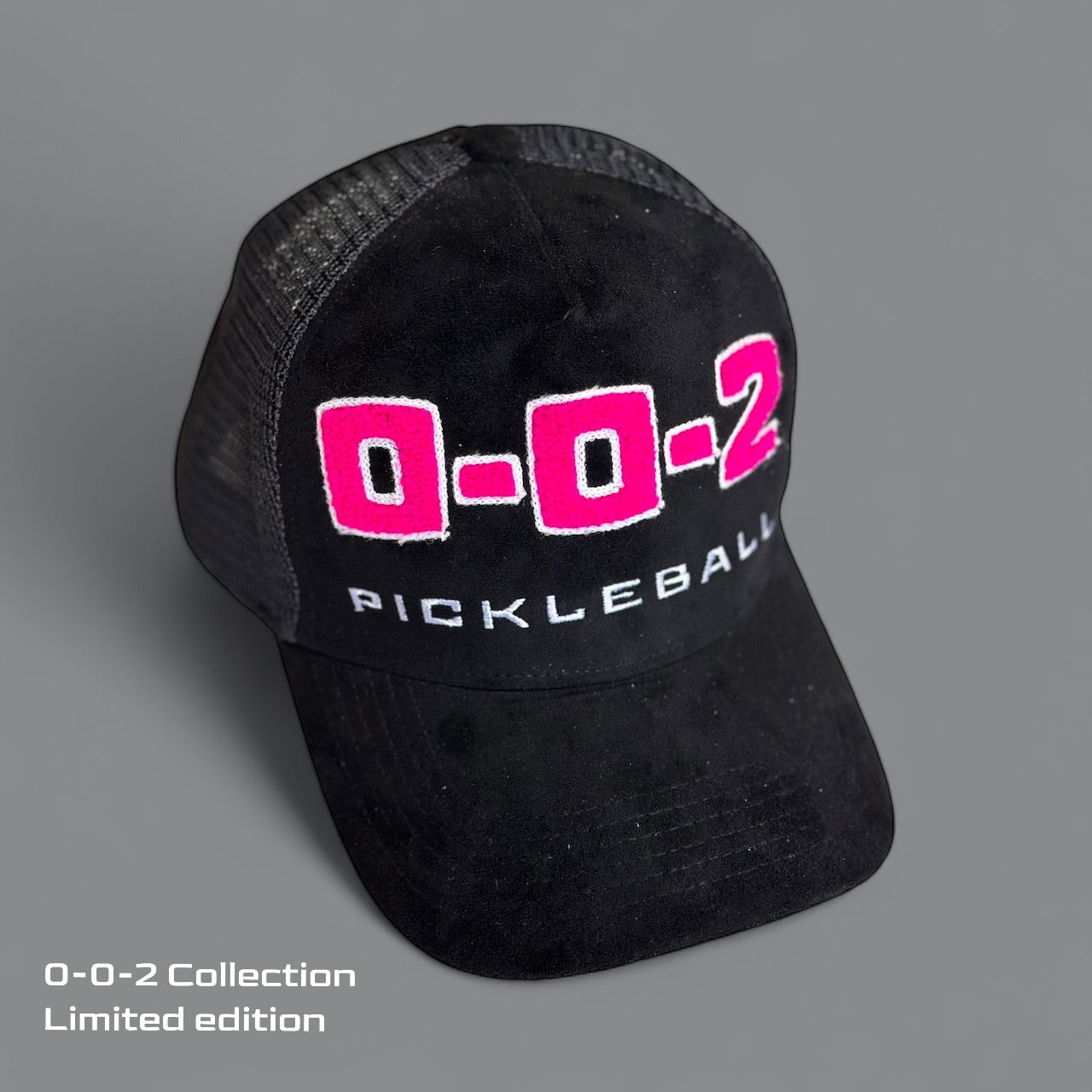 A black mesh Potenza Pickleball "0-0-2" Collection Hat (0-0-START) features bold pink and white chenille embroidery on the front. Displayed on a gray background with "0-0-2 Collection limited edition" in white blocky font at the bottom left.