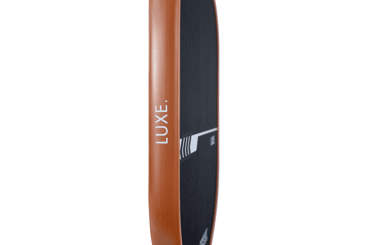 A close-up side view of the LUXE Pickleball Finesse paddle shows a brown edge and black grip tape. "LUXE." is printed vertically in white on the side. Its carbon fiber build offers ultimate control, displayed against a plain white background.