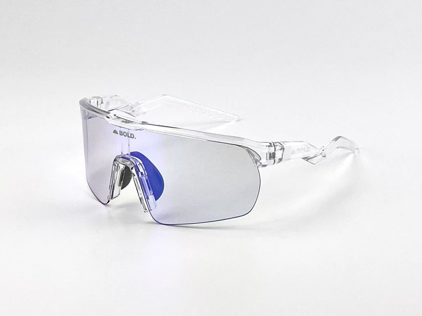 The BOLD Flash Photochromic Sunglasses by boldouterwear feature a single wraparound tinted lens, clear plastic frame, nose bridge, and side shields. “BOLD.” is printed on the top left of the lens. Shown on a plain white background.