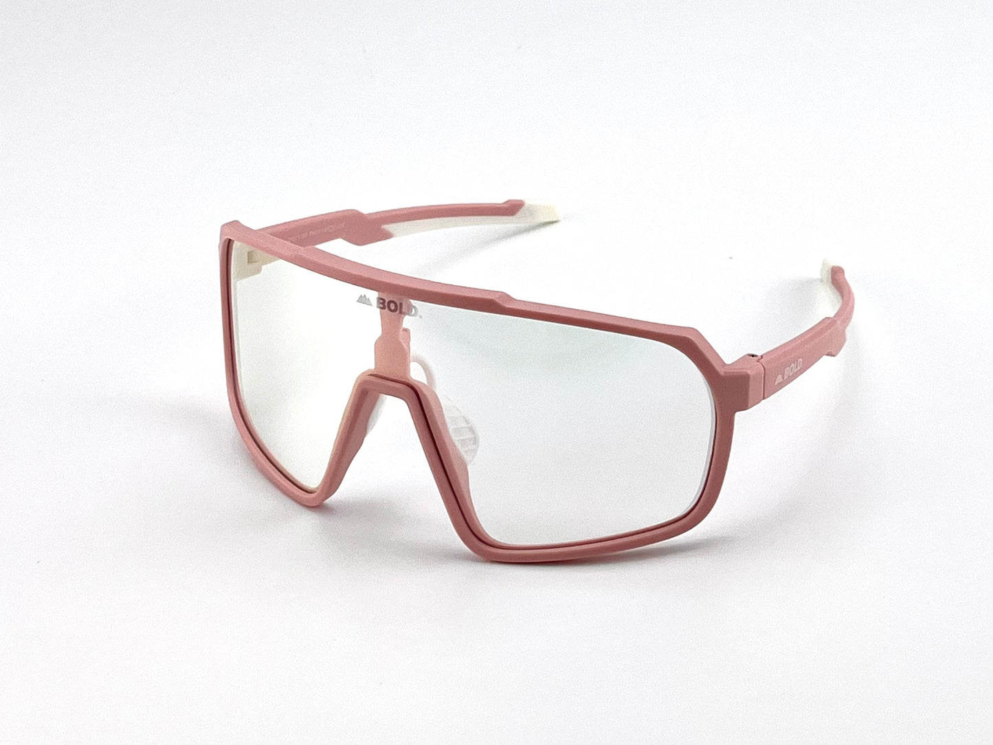 BOLDouterwear BOLD Slayers Photochromic Sunglasses feature large, wraparound pink frames, clear light-adaptive lenses, angular design with a bold nose bridge, white ear tips, and "BOLD" printed on the side. Shown on a plain white background.