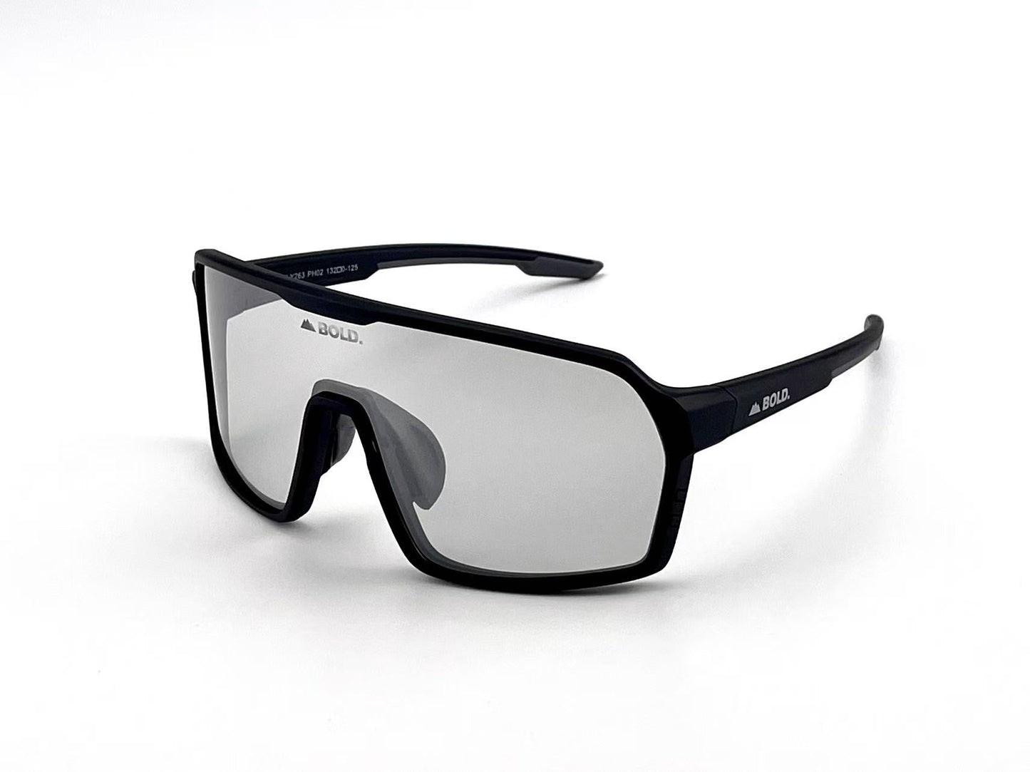 A pair of BOLD Drift Photochromic Sunglasses from boldouterwear featuring sporty black angular frames, a thick top bar, and large single-piece mirrored lenses. “BOLD.” is printed in white on the lens and both temple arms. White background.