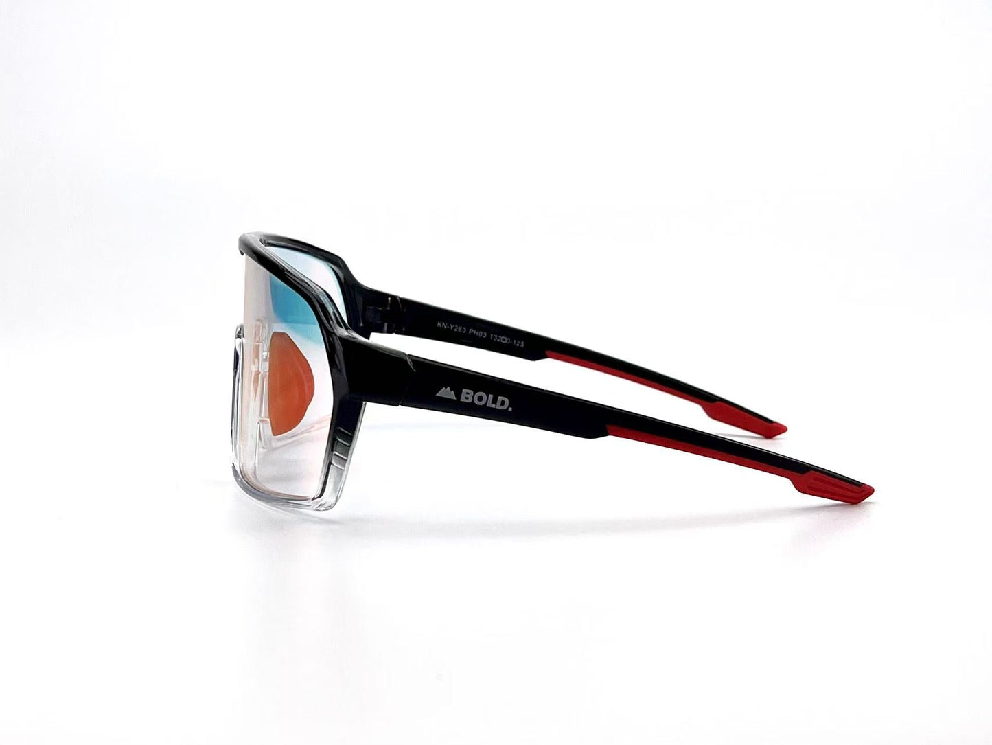 The BOLD Drift Photochromic Sunglasses by boldouterwear feature clear lenses that adapt to light, transparent fronts, and black-red arms with "BOLD." in white. The glasses are angled to show the right side. Ideal for MTB, ski, and lifestyle use.