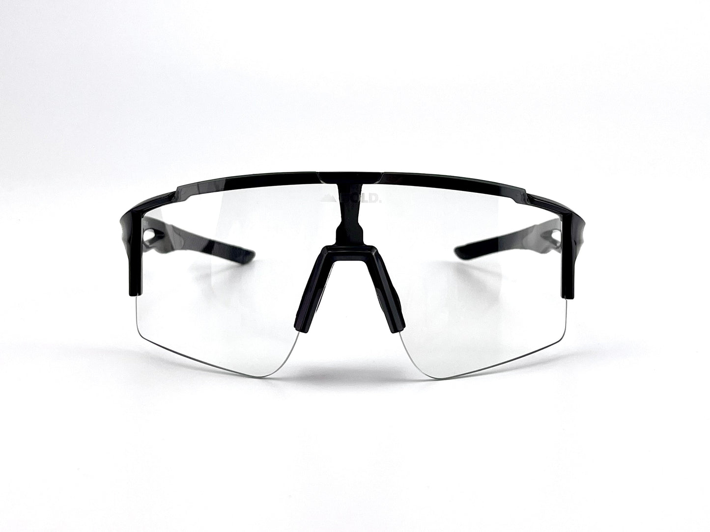 The boldouterwear BOLD Wavelength Performance Sunglasses feature clear, frameless lenses, a black top frame, and sleek black arms—ideal for MTB, ski, and lifestyle use. Their modern design delivers top performance against a plain white background.