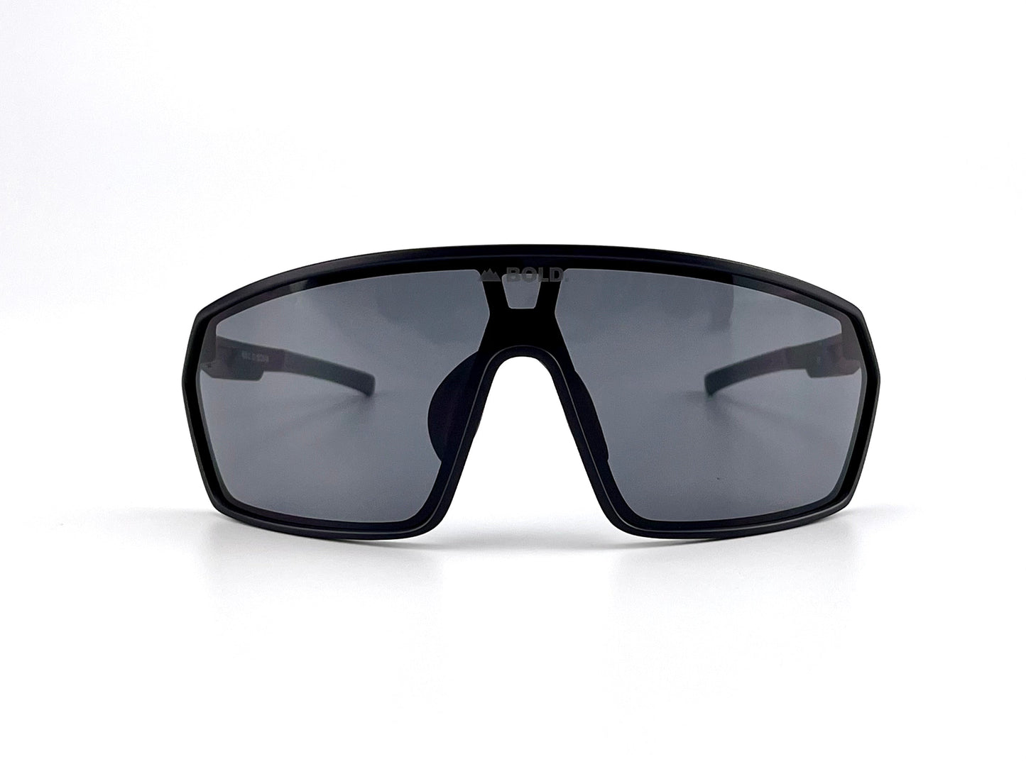 The BOLD NSP Performance Sunglasses by boldouterwear are black, sporty, wraparound shades with large dark-tinted lenses, designed for smaller faces. Shown front-facing on a white background; ideal for MTB, ski, and lifestyle use.