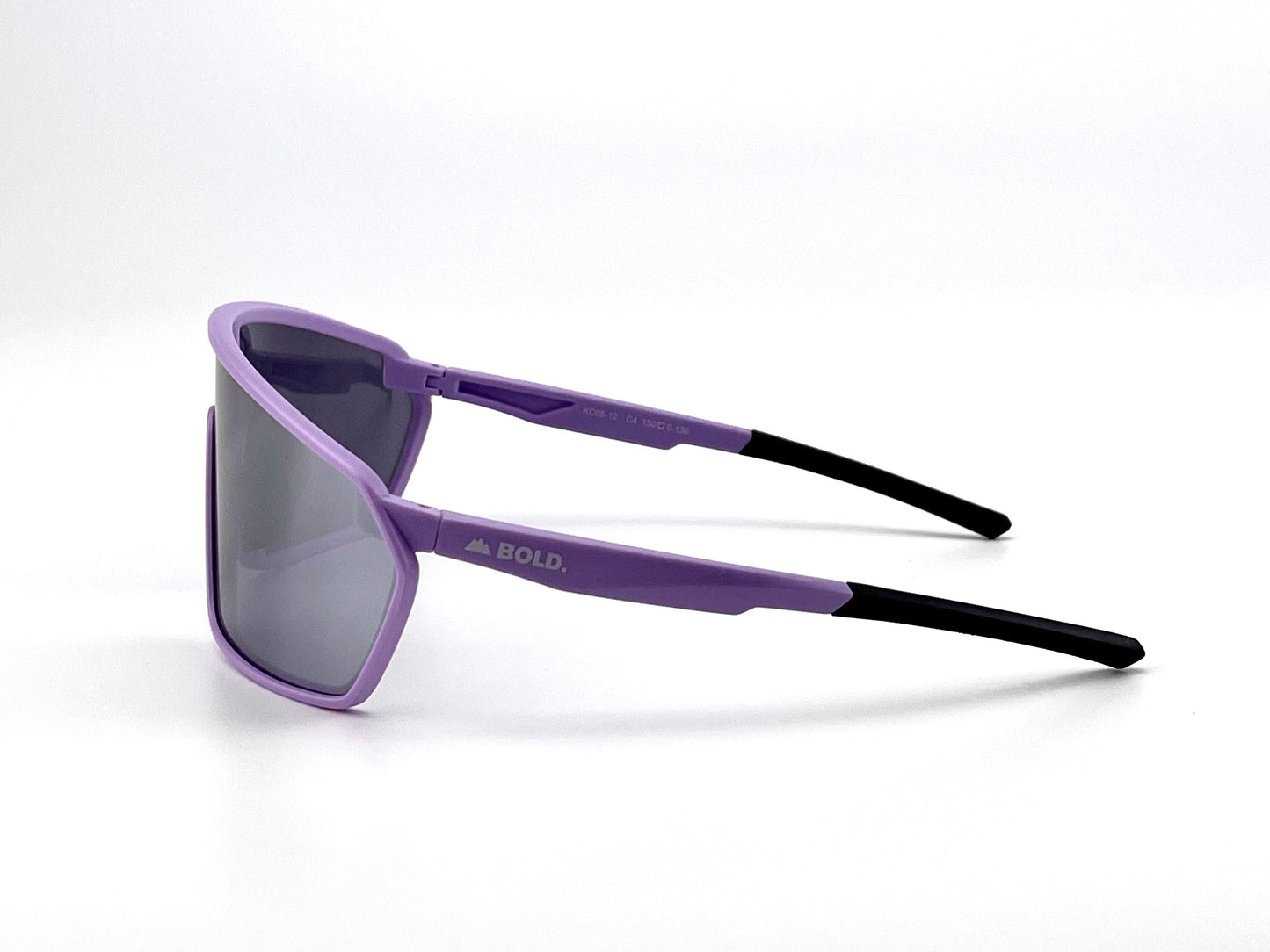 The BOLD NSP Performance Sunglasses by boldouterwear feature rectangular mirrored lenses, a light purple frame for smaller faces, and purple temples with black tips. "BOLD." is printed in white on the side. They're angled left against a white background.