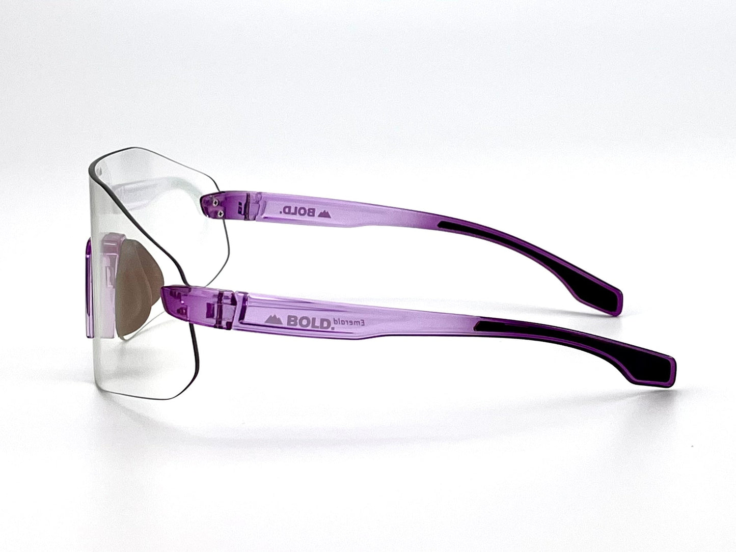 The BOLD Emerald Photochromic Sunglasses by boldouterwear feature frameless rectangular, light-adaptive lenses, light purple translucent arms with "BOLD" temple branding, smoothly curved arms with black tips, set against a plain white background.