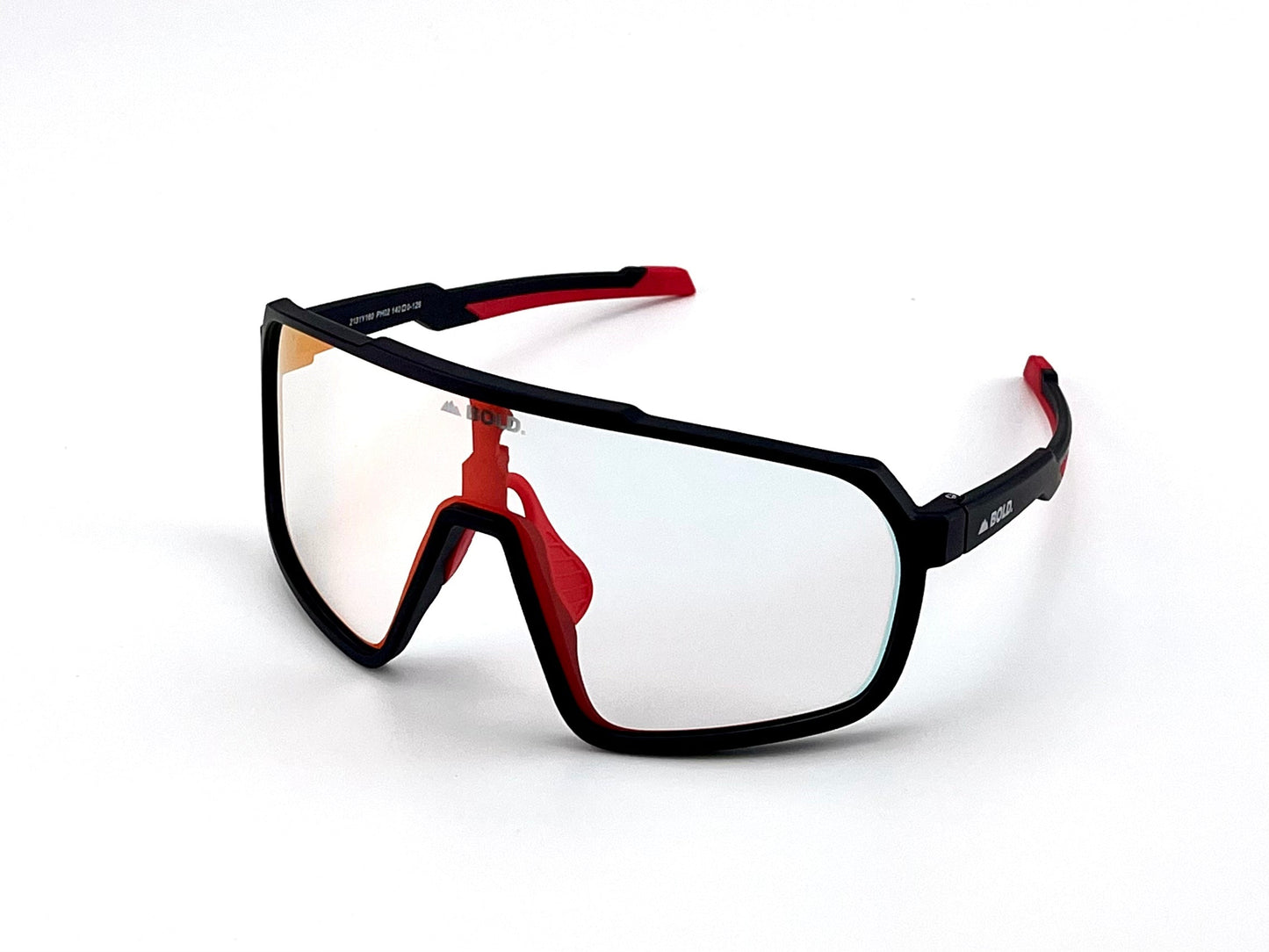 The BOLD Slayers Photochromic Sunglasses by boldouterwear feature an oversized black frame with red on the nose bridge and temple tips, a large light-adaptive shield lens, and angular arms—perfect for MTB, ski, or lifestyle wear.
