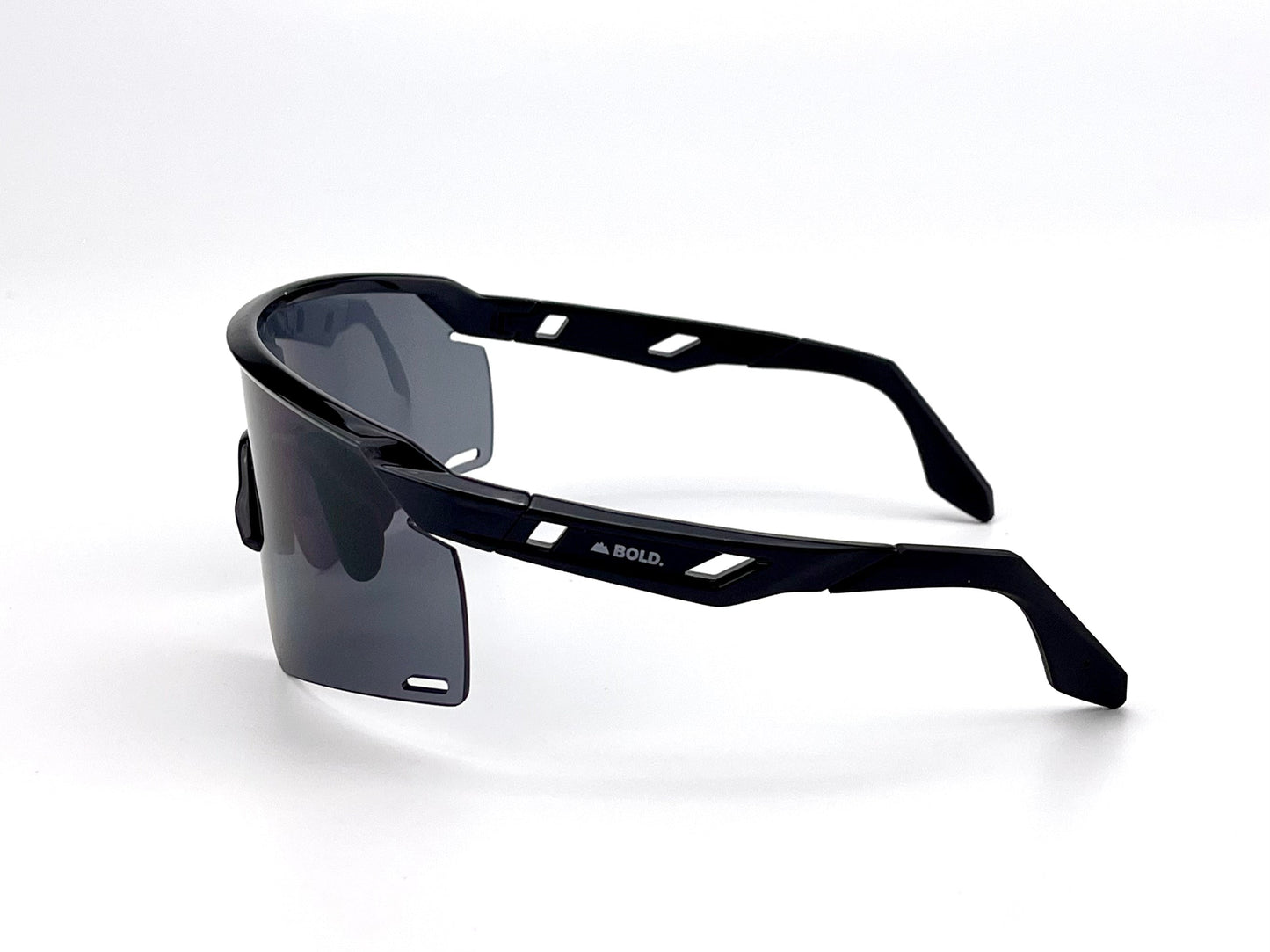 The BOLD Bearclaw Performance Sunglasses by boldouterwear are black, oversized shield sunglasses with a single dark lens, angular frames, and geometric arm cutouts featuring "BOLD." in white. Shown on a plain white background.