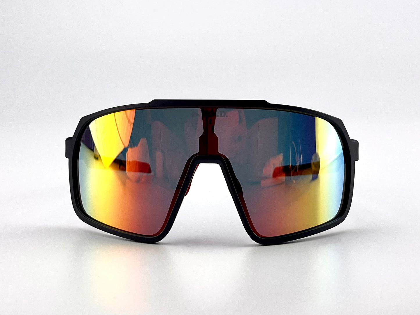 The BOLD Slayers Performance Sunglasses by boldouterwear feature a thick black frame and large, single-piece mirrored lenses with yellow, orange, and red hues. Their oversized wraparound design is shown facing forward on a plain white background.