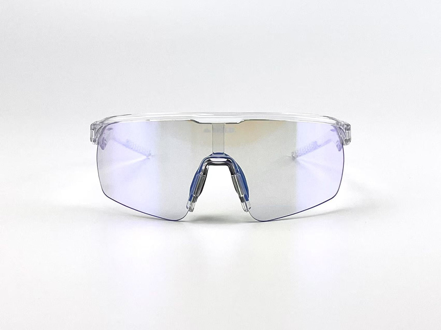 The BOLD Flash Photochromic Sunglasses by boldouterwear feature a transparent, rimless design with a single wide lens, blue-tinted nose pads, and thin arms, shown facing forward on a white background. Ideal for MTB, ski, and lifestyle wear.
