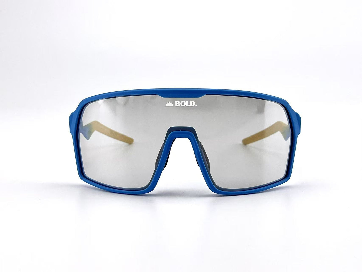 The BOLD Glow Photochromic Sunglasses by boldouterwear feature sporty blue frames, large mirrored non-polarized lenses with "BOLD." in white at the top center, and a modern angular design set against a plain white background.