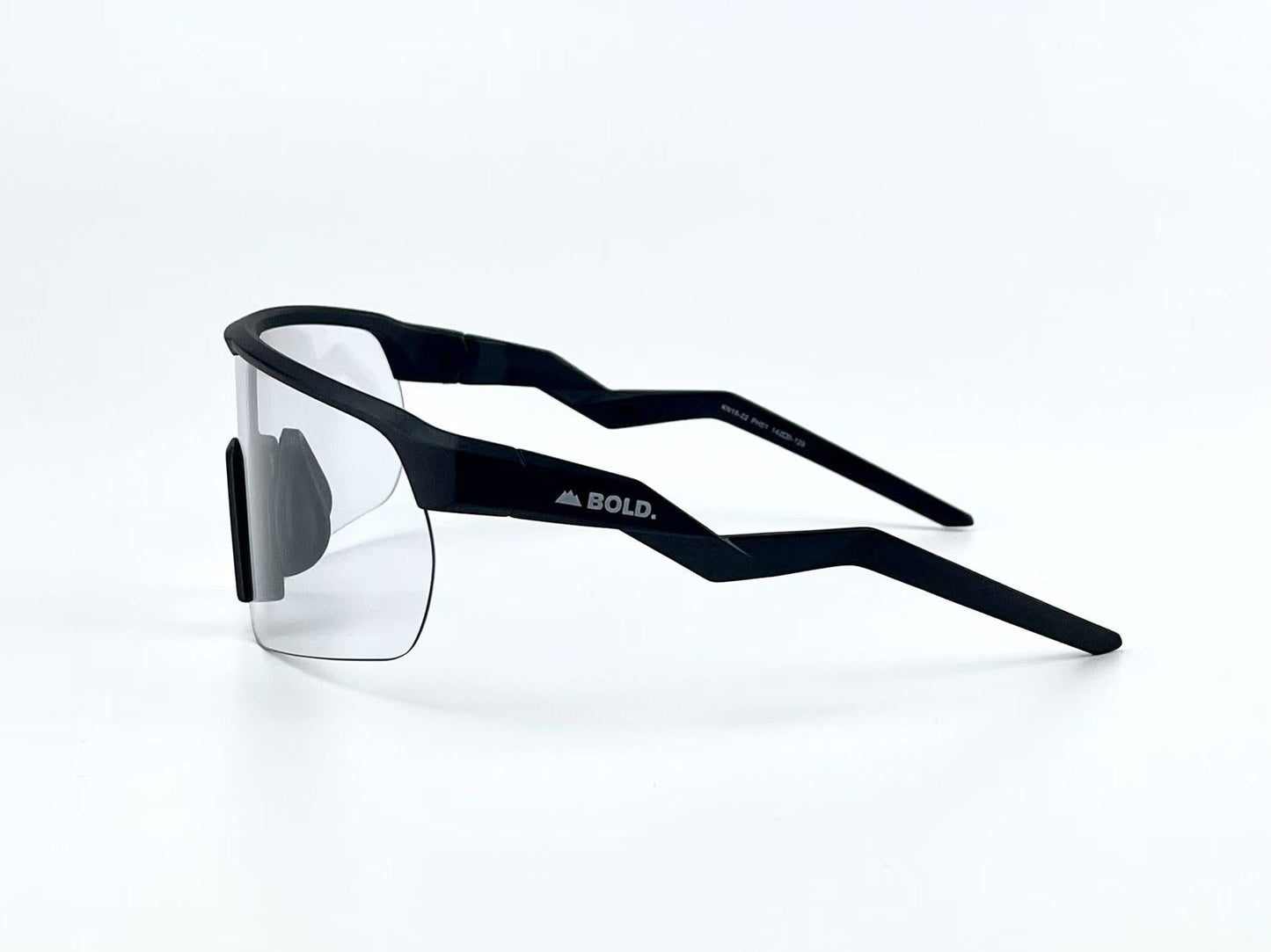 BOLD Flash Photochromic Sunglasses by boldouterwear feature a sleek black angular frame, clear single-piece lens, and sharply zigzagged arms. "BOLD." with a mountain logo appears in white on the side. Background is plain white.