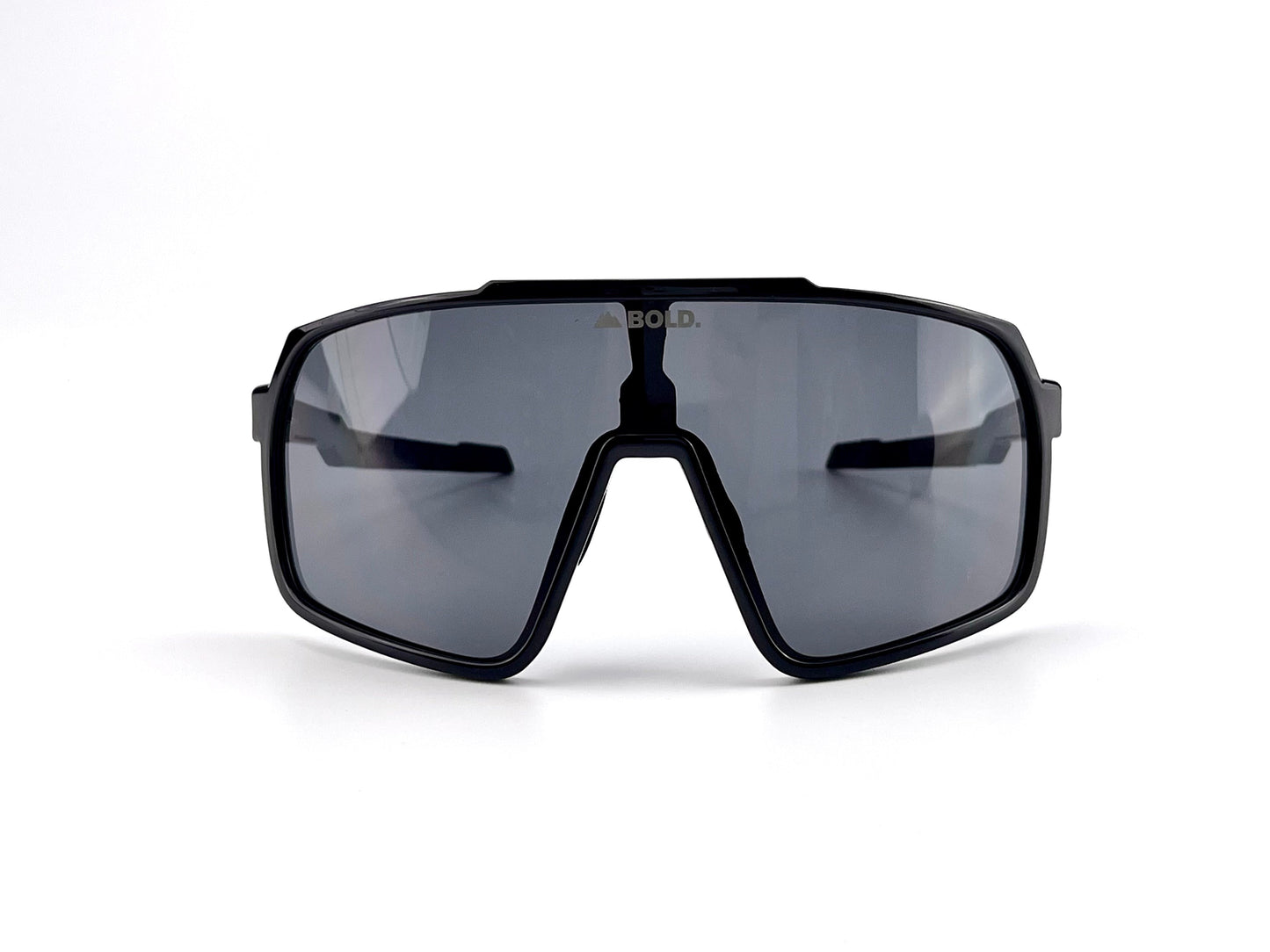 Shown against a plain white background, the BOLD Slayers Performance Sunglasses from boldouterwear feature a large, black oversized wraparound frame with dark, reflective lenses and bold, sporty design. The brand name appears faintly above the nose bridge.