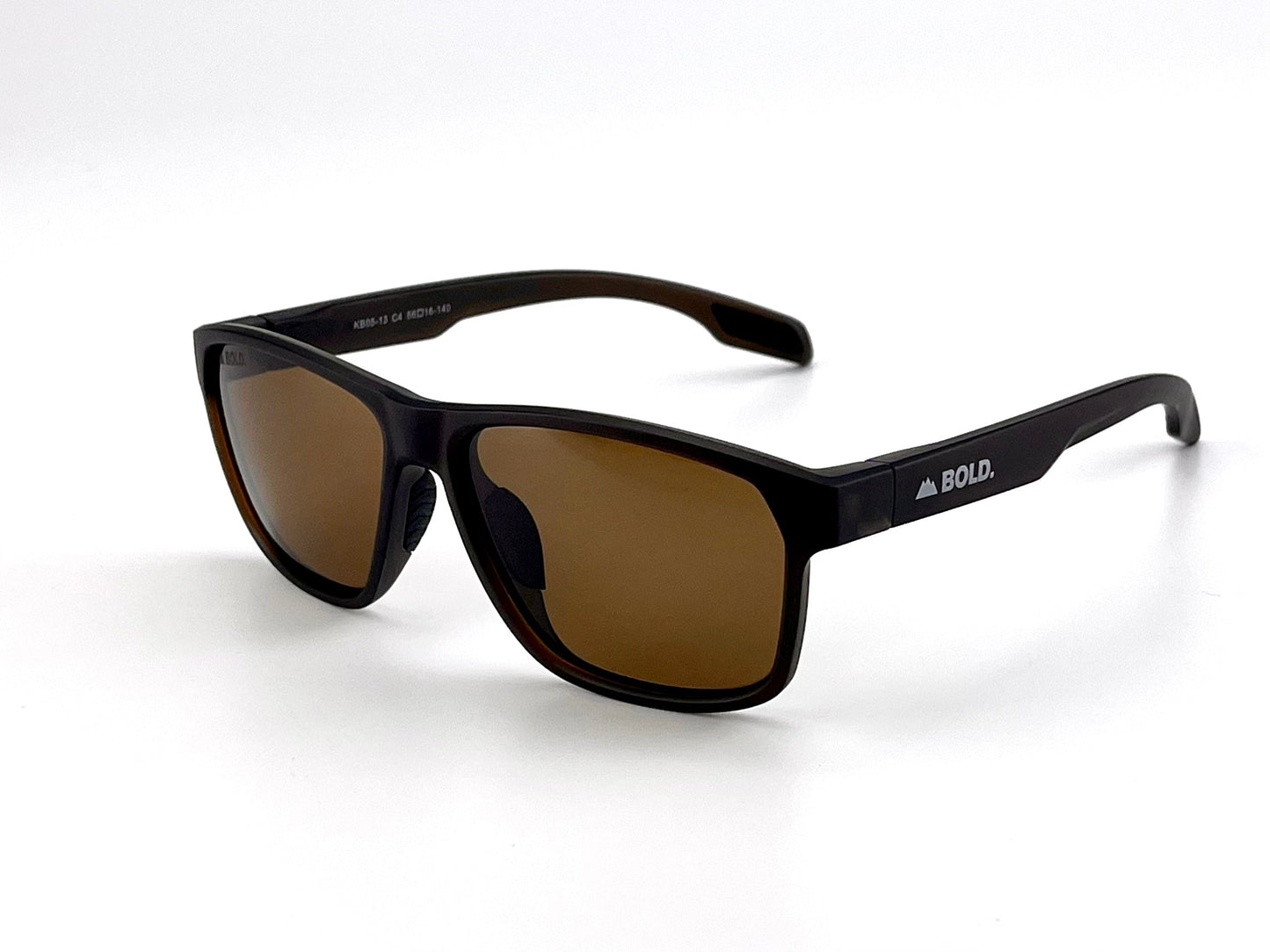 The BOLD Thunderhead Performance Sunglasses by boldouterwear feature a glossy black rectangular frame with wide arms, brown fixed-tint lenses, and "BOLD." in white with a triangle logo on the left arm. Offers stylish UV protection for MTB, ski & lifestyle.