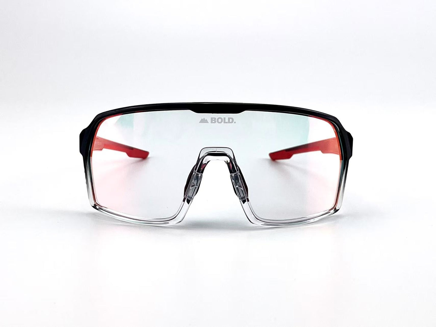 The BOLD Drift Photochromic Sunglasses by boldouterwear feature a single wide gradient lens, black-on-top/clear-on-bottom frame, and red arms. "BOLD." is printed on the bridge above the nose pads. Background is white.