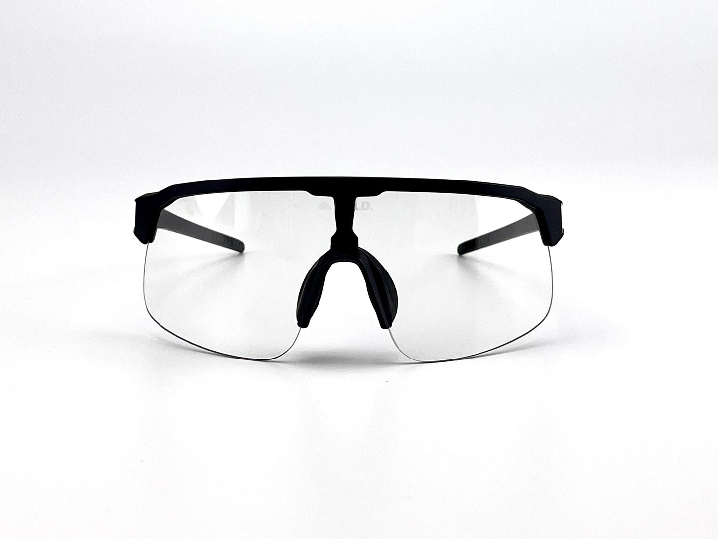 The BOLD Zippy Photochromic Sunglasses by boldouterwear feature a matte black frame, clear rimless lenses, and black nose pads and arms. A plain white background accentuates the minimalist design of these MTB, ski & lifestyle safety glasses.
