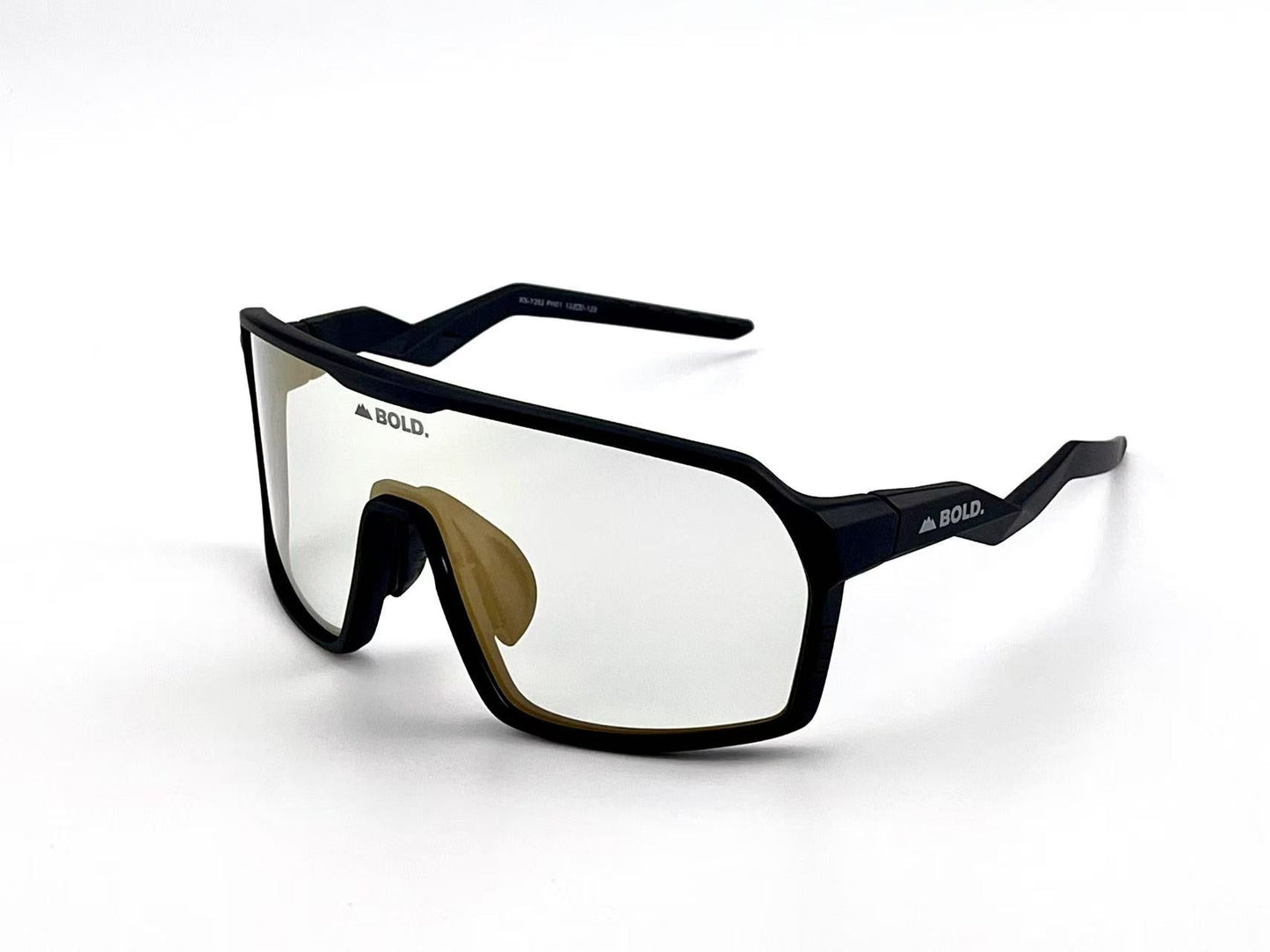 The BOLD Glow Photochromic Sunglasses by boldouterwear feature sporty black rims, a large wraparound lightly reflective lens, angular arms, and the BOLD. logo on both lens and frame—perfect for MTB, ski, and lifestyle use.