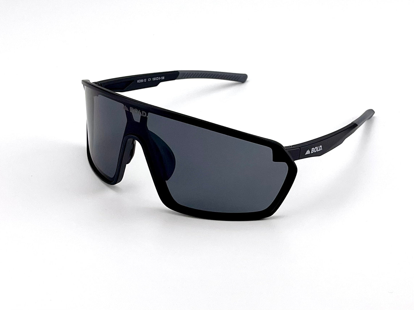 The BOLD NSP Performance Sunglasses by boldouterwear feature an oversized black frame, single wraparound dark lens, and thick arms. "BOLD" branding appears in white on the lens and arms. Shown on a white background; ideal for MTB, ski & lifestyle use.