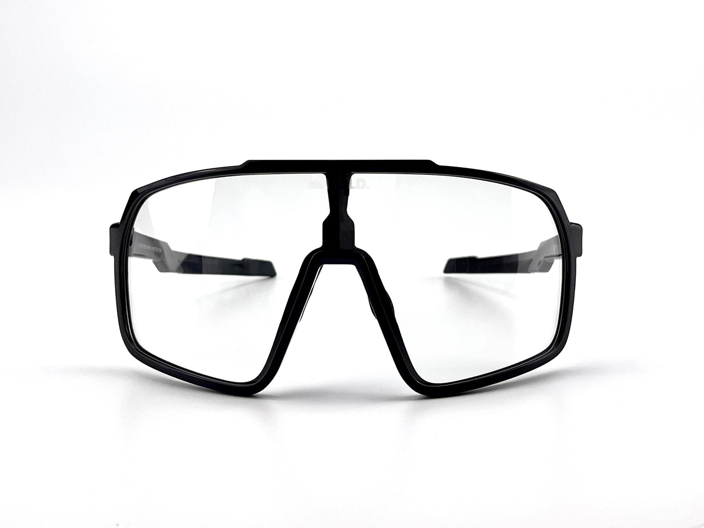 Front view of BOLDouterwear BOLD Slayers Photochromic Sunglasses—black, oversized sports eyewear with clear light-adaptive lenses, bold angular frame, and wide temples—shown on a plain white background.