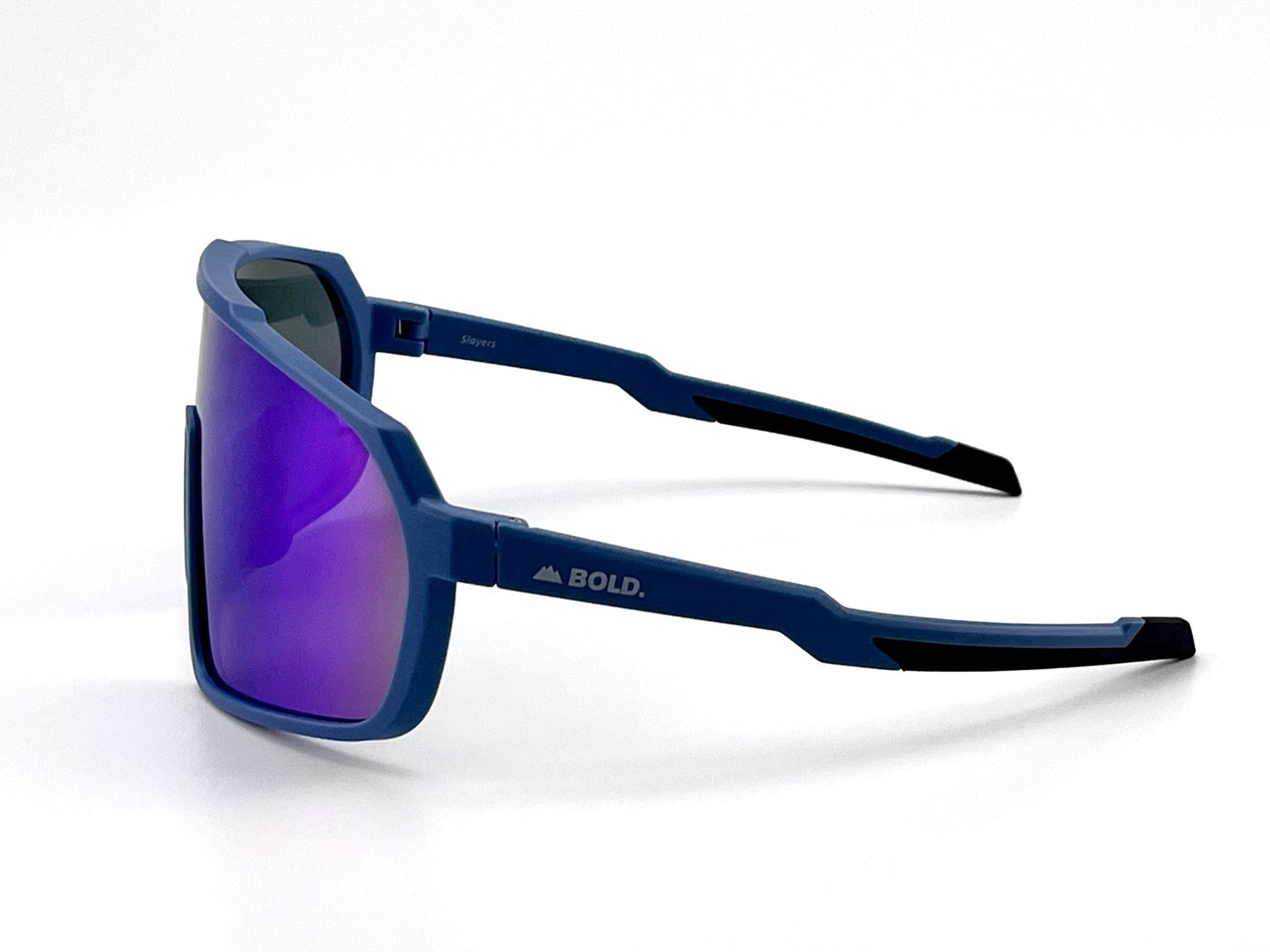 The BOLD Slayers Performance Sunglasses by boldouterwear feature angular, oversized blue frames, purple mirrored lenses, black-accented tips, and white "BOLD." branding for a modern geometric look and comfortable wraparound fit—ideal for MTB, ski, or lifestyle wear.