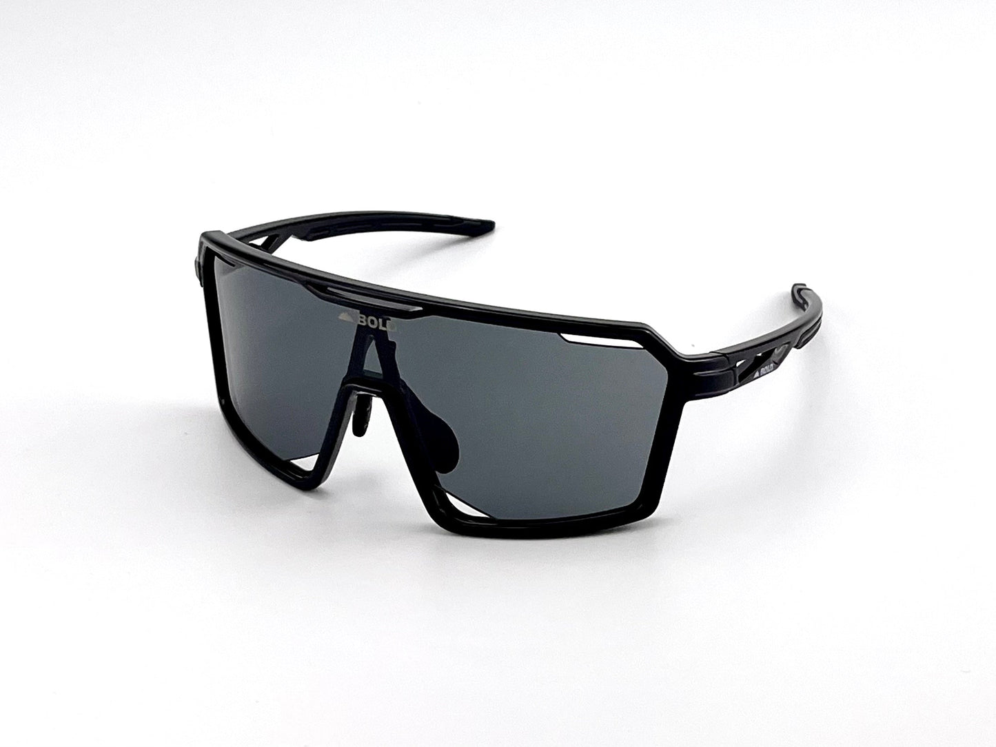 BOLD Flux Performance Sunglasses by boldouterwear feature an angular black frame with large, dark reflective lenses for MTB, ski, and lifestyle use. The contemporary geometric design offers UV protection and stands out against a white background.