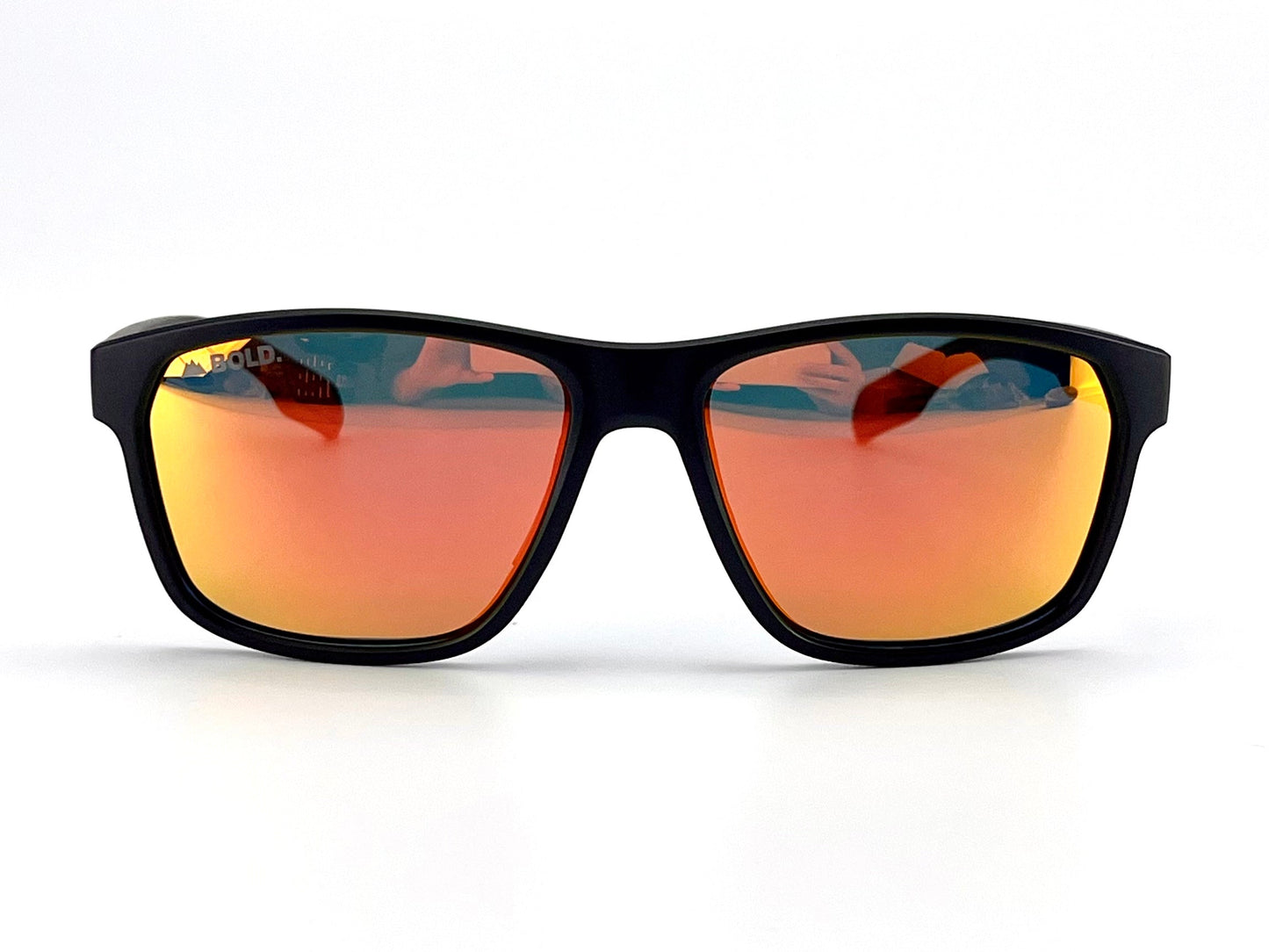 The BOLD Thunderhead Performance Sunglasses by boldouterwear, featuring large black rectangular frames and orange mirrored lenses with UV protection, are shown facing forward on a plain white background. The lenses subtly reflect a person and indistinct objects.