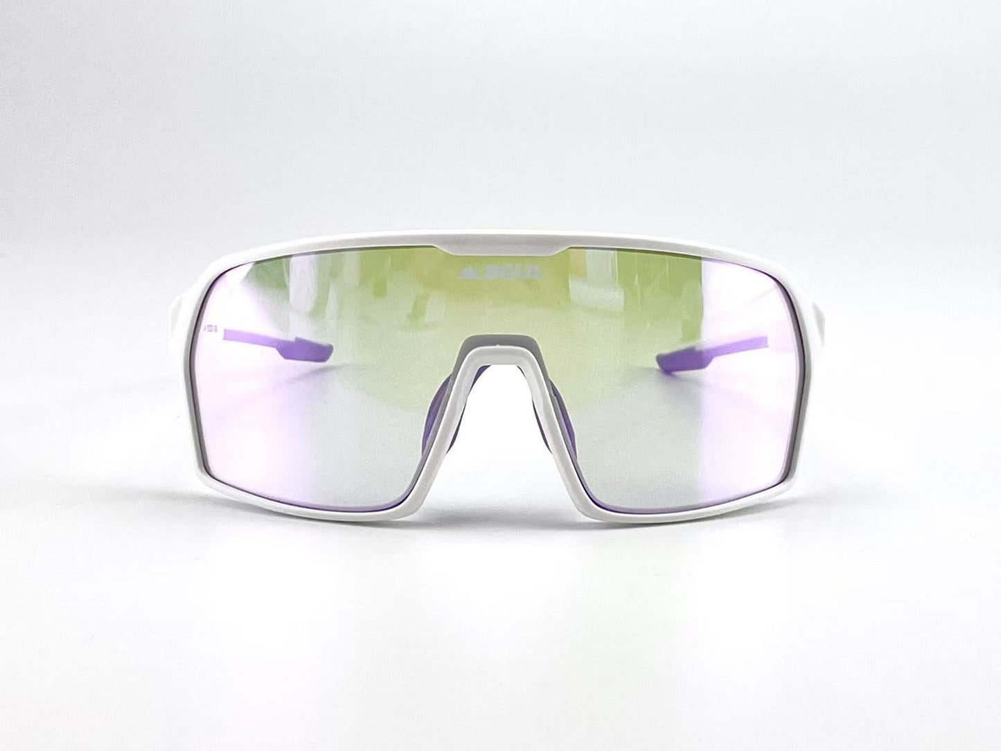 Front view of the BOLD Drift Photochromic Sunglasses by boldouterwear, featuring a white frame and a single large, reflective lens with purple-yellow tint. Wide angular arms are set against a plain white background. Ideal for MTB, ski & lifestyle.