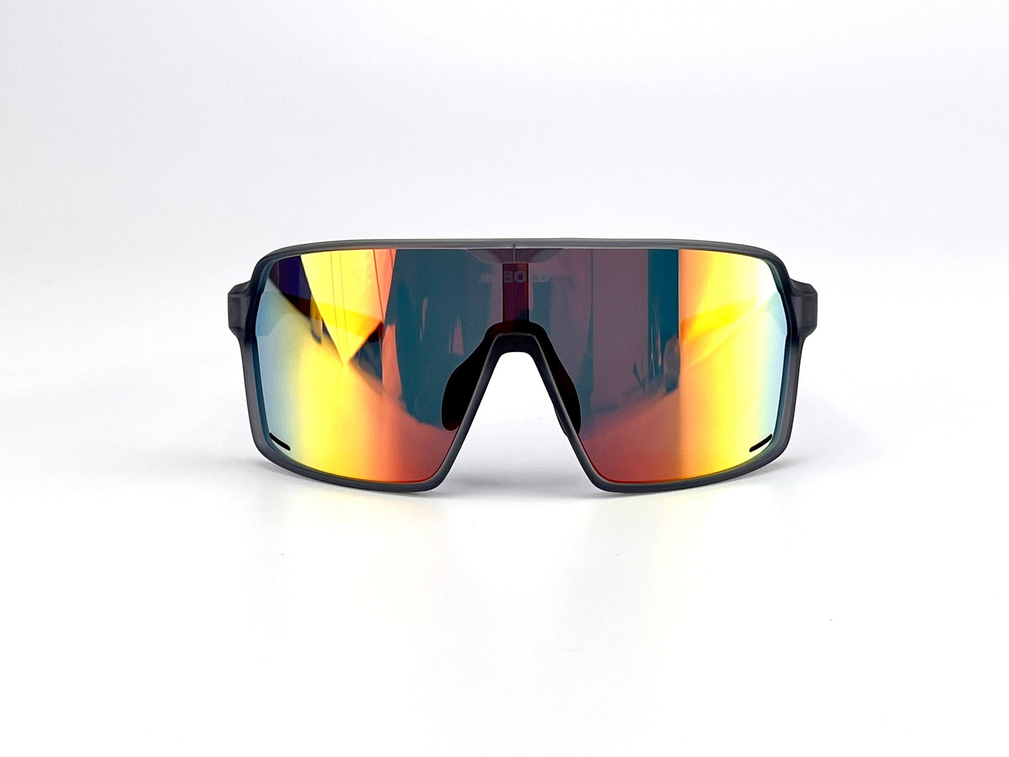 The BOLD Shadows Performance Sunglasses by boldouterwear feature a large, single wraparound lens with yellow, orange, and blue gradients, reflective fixed-tint lenses, and a minimal black frame outlining the top and sides. Plain white background.