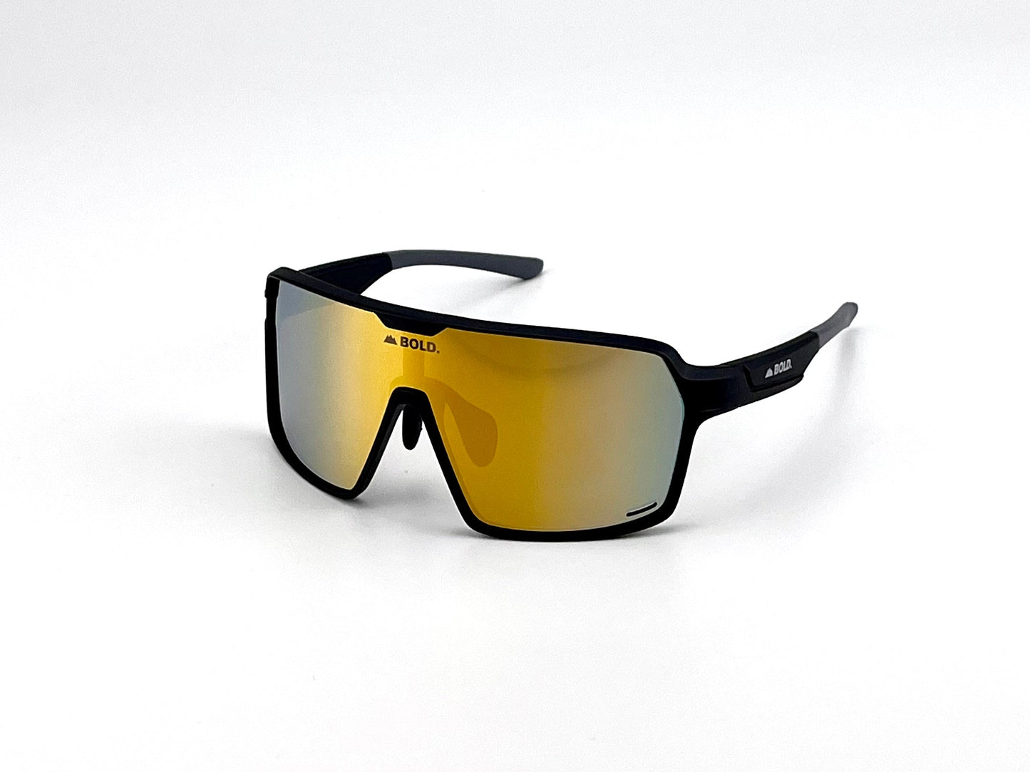 The BOLD Shadows Performance Sunglasses by boldouterwear feature a black frame, single wide yellow-tinted fixed lens, bold angular wraparound design, and thick arms. "BOLD." branding appears on the lens top center and left arm. Plain white background.