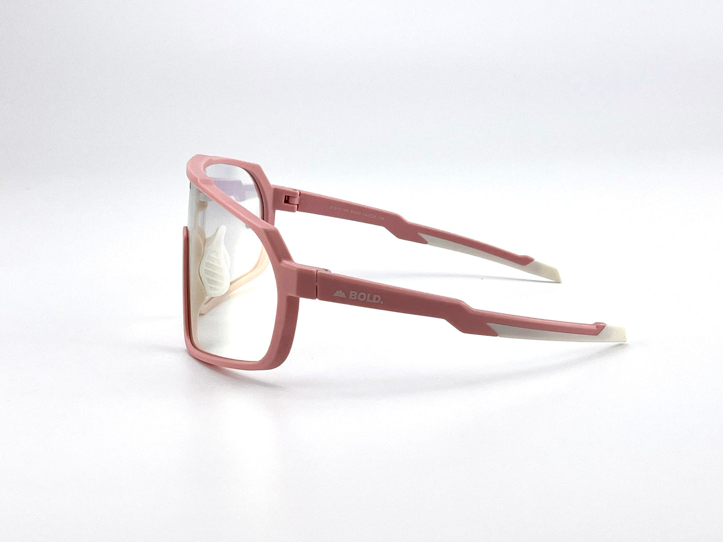 The BOLD Slayers Photochromic Sunglasses by boldouterwear feature a rectangular, pink oversized frame with white-tipped arms, "BOLD" branding, light-adaptive lenses, and a reinforced nose bridge for MTB, ski, and lifestyle use.