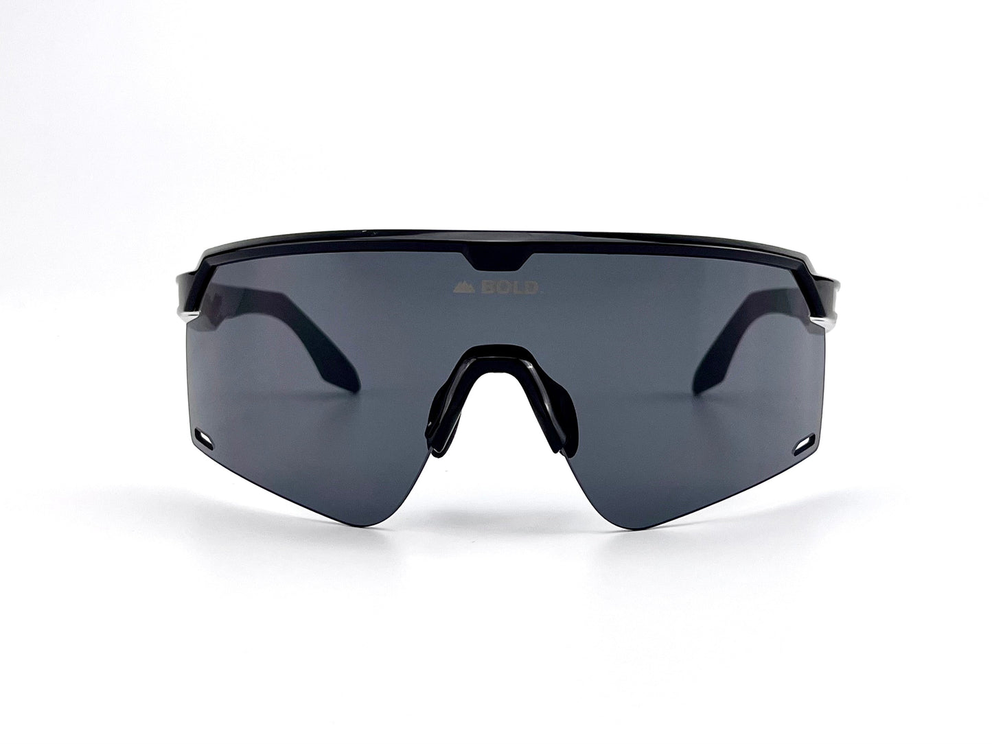 The BOLD Bearclaw Performance Sunglasses by boldouterwear feature sleek, black oversized shield frames with a single large dark lens and nose pads. "BOLD" is faintly visible at the top center of the lens, shown on a plain white background.