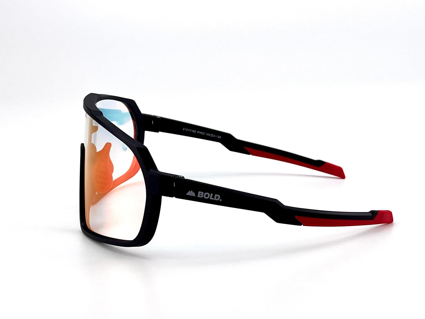 The BOLD Slayers Photochromic Sunglasses by boldouterwear feature a matte black oversized frame with red temple tips, mirrored orange lenses, and the BOLD. logo with a mountain graphic on the side, set against a plain white background.
