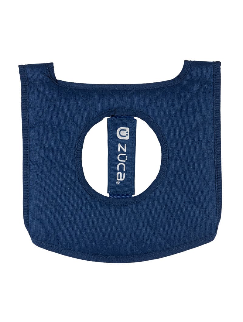 The ZUCA Reversible Seat Cushion is a navy blue, quilted accessory with diamond stitching, curved edges, and a center hole featuring a vertical strap with the white ZUCA logo. This padded cushion offers both style and comfort.