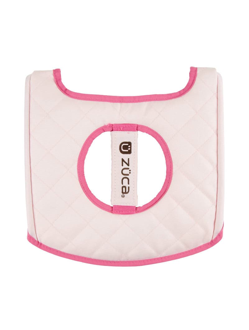 The ZUCA Reversible Seat Cushion is a quilted, light pink padded cushion with a circular center cut-out, pink border, and vertical rectangular "ZUCA" label—ideal for decorative or protective seating.