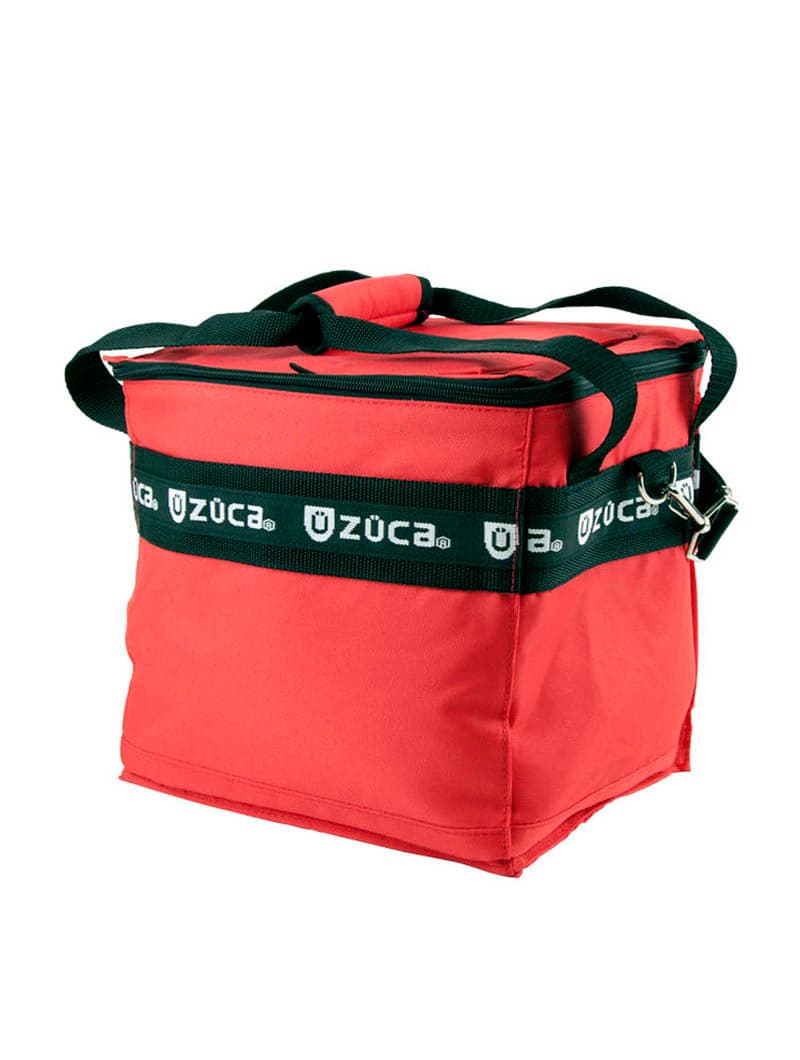The ZUCA Cooler is a red, insulated square bag with black carrying handles, a strap featuring ZUCA and shield logos in white, a black zipper, and a silver buckle—sturdy and structured for use with ice packs.