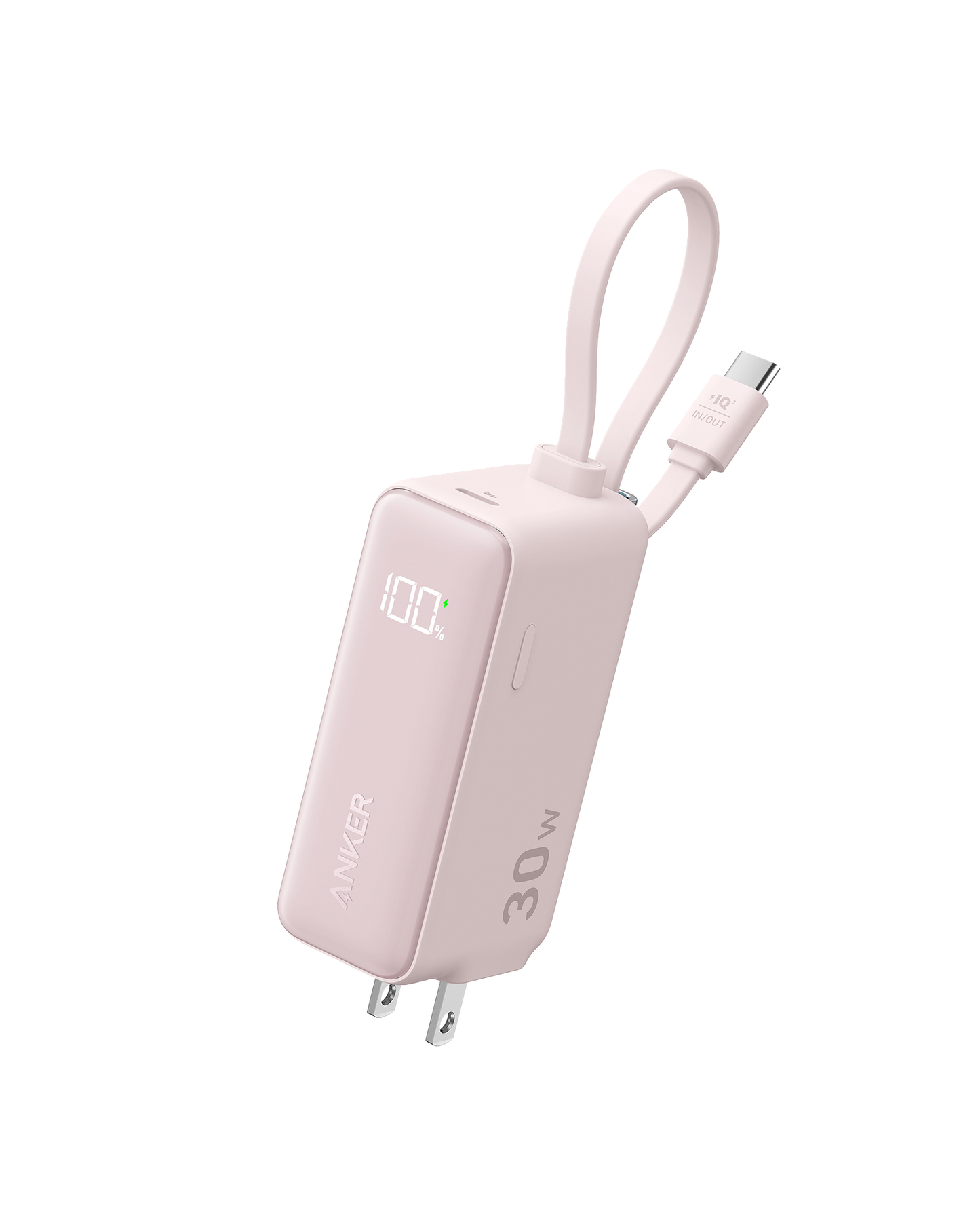 A pink Anker Power Bank (30W, 5k, Fusion) with a built-in display showing “100%,” foldable prongs, and an attached short USB-C cable looped for easy carrying, is set against a plain white background.
