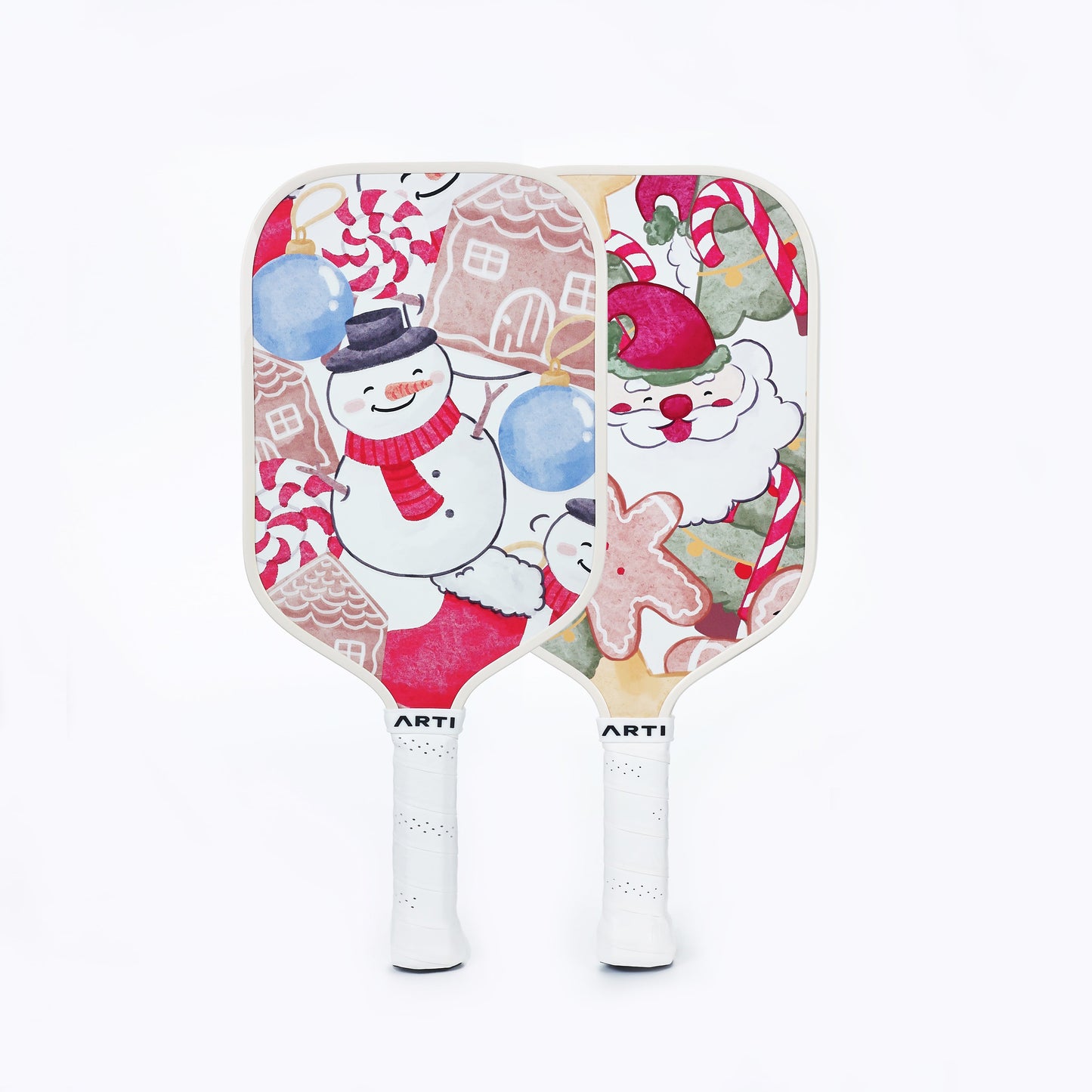 The ARTI Fiberglass "Christmas Edition" Pickleball Paddle set features two festive paddles: one with a snowman, snowflakes, gingerbread houses & candy canes; the other with Santa, candy canes & ornaments. Perfect for holiday games!.