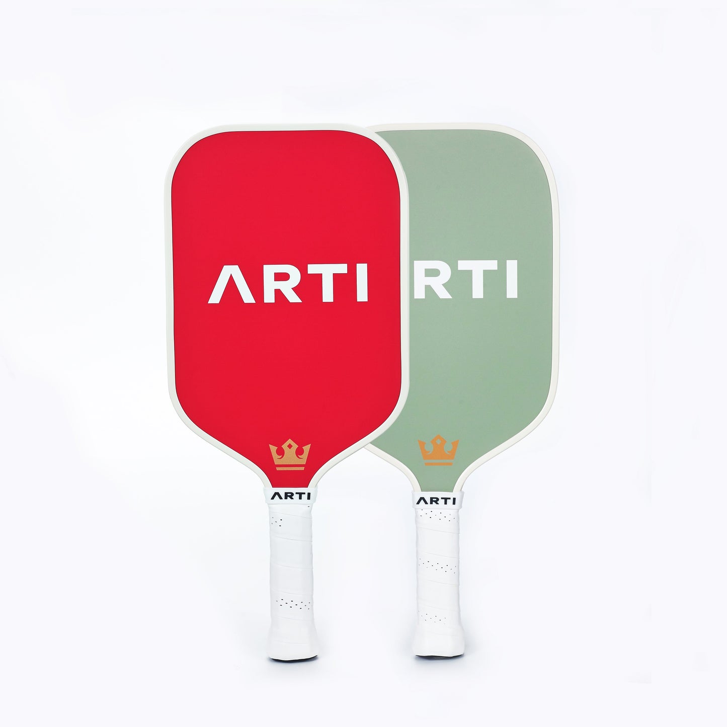 The ARTI Fiberglass "Christmas Edition" Pickleball Paddle set features two upright paddles—one red, one sage green—each with white "ARTI" branding and a gold crown icon near the white handle grips, displayed on a white background.