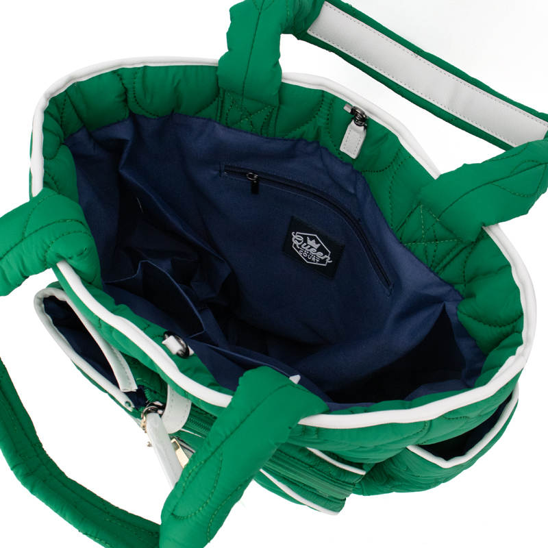 The Queen of the Court Fifth Ave Pickleball Convertible Tote Bag/Backpack features padded handles, a green-and-white quilted exterior, a navy interior with a zippered pocket, labeled compartments, and spacious storage.