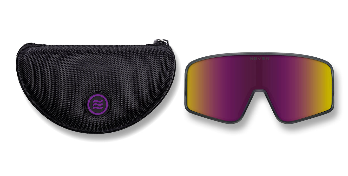 A black textured zippered case with a purple logo sits beside Neven Eyewear’s Mattingly sunglasses—wide, frameless, with gray frames and yellow-to-purple mirrored gradient lenses. "NEVEN" appears faintly on the lens. Ideal for a vintage baseball game or Yankees radio.